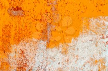 Old metal background painted in orange and white with rust and chipped.