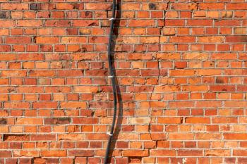 Electrical power cable wiring on old brick wall background texture