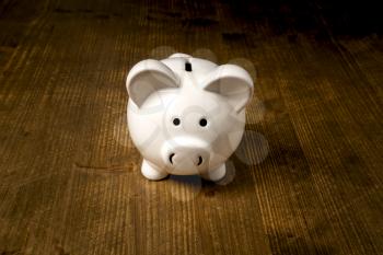Piggy bank on the old wooden background. Money savings, financial concept.