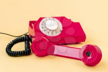 Old landline phone on yellow background. Hotline phone, call center, customer service help desk or contacts on site. 