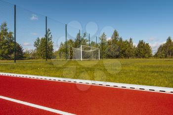 Outdoor running track with behind soccer goals