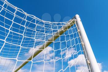 Top corner of a football goal against blue sky