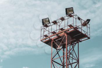 Tall tower with spot lights or lamps for railway station