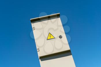Outdoor electric high voltage cabinet on blue sky background
