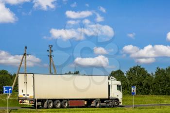 Road transport of goods by truck.Truck driving on the asphalt road in rural landscape 