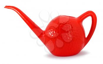 Plastic red watering can on white bcakground