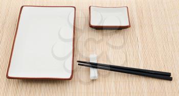 Sushi accessories on yellow bamboo background