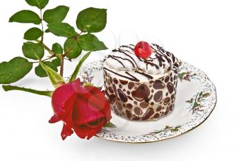 Round cake souffle, cream white with stripes of chocolate icing and red jelly on a plate with a red rose isolated on white background