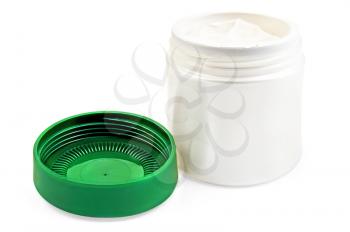 Face cream in a white open a jar, a green cap isolated on a white background