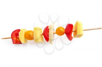 Sweet red pepper, potato wedges, onion, small yellow tomatoes on a wooden skewer is isolated on a white background