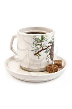 Porcelain cup of coffee and two slices of brown sugar in isolation on a white background
