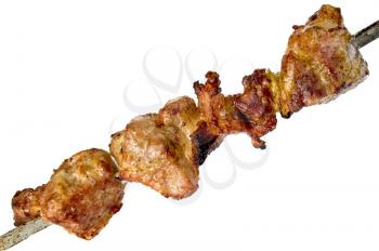 Slices of fried meat and onions on a skewer isolated on a white background