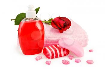 Red liquid soap in a bottle, solid striped red and pink soap, bath salt, pink towel and red rose isolated on white background