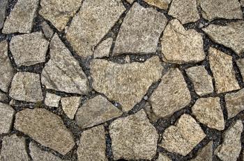 The pavement of granite blocks and black gravel (texture)