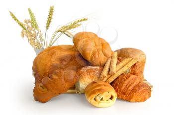 White bread, rolls, croissant, bread sticks, stalks of wheat, rye and oats in a porcelain vase isolated on white background