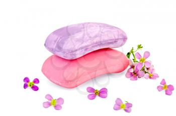 Two bars of soap pink and lilac, small flowers isolated on white background