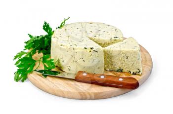 Homemade round cheese with herbs and spices cut, knife on a round wooden board isolated on white background