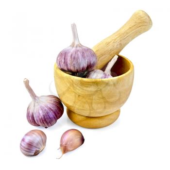 Whole and cloves of garlic bulbs in a wooden mortar and on the table isolated on white background
