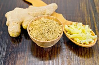 Wooden bowl with powder and a wooden spoon with grated ginger, ginger root on the background of wooden board