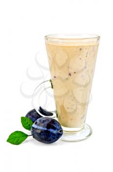 Milk shake in a glass beaker, two black plums with green leaves isolated on white background