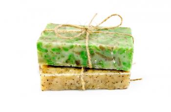 Yellow and green handmade soap, tied with string isolated on white background