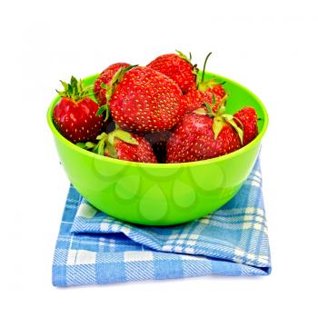 Strawberries in a green plastic bowl on a blue checkered napkin isolated on a white background