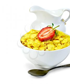 Cornflakes in a white bowl with strawberries and milk in a jug, a spoon isolated on white background