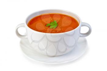 Tomato soup in a white bowl with parsley on a plate isolated on white background