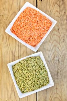Red and green lentil in white bowls on a wooden boards background
