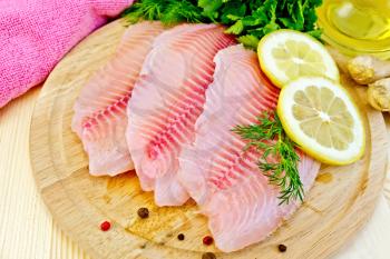 Tilapia fillets with dill, lemon, ginger, cloth, vegetable oil in a decanter on a wooden boards background