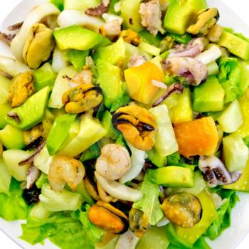 Salad from shrimps, octopus, mussels and calamari with avocado, lettuce, pineapple isolated on white background top