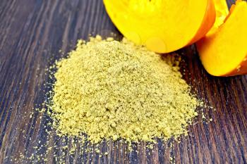 Flour pile pumpkin, slices of fresh pumpkin on a wooden boards background