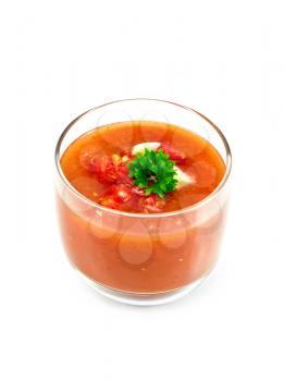 Tomato soup gazpacho in a glass with parsley isolated on white background