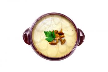Mushroom puree soup with chanterelles in a clay bowl isolated on white background from above