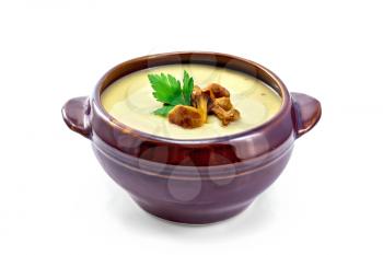 Mushroom soup with chanterelles in a clay bowl isolated on white background