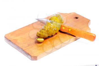 Royalty Free Photo of a Pickle on a Cutting Board