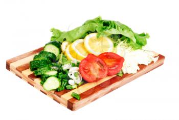 fresh fruits and vegetables on a bamboo cutting board
