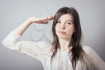 Portrait of young woman saluting
