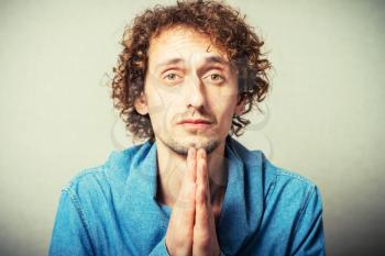curly-haired man prays