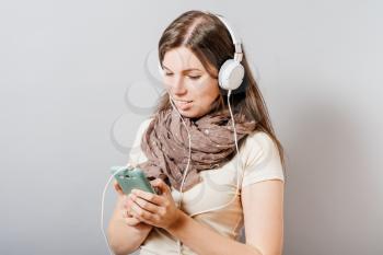 girl in headphones with a mobile