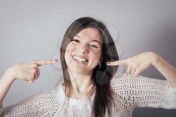 Woman showing her perfect straight white teeth.