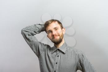 smiling casual man relaxing with hands behind back