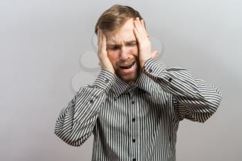 Portrait of young sad man worrying or having pain