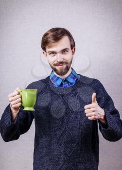 young man happy with a cup of tea