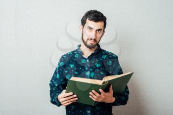 Young hipster man reading a book