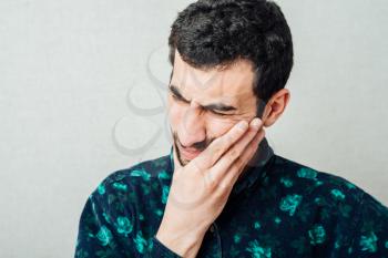 Toothache - suffering young man with teeth problems