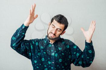 young man  in despair, with hands raised up