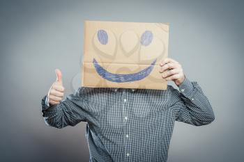 Man with the painted happy smile on the sheet of paper