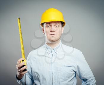 The builder in a helmet with a meter