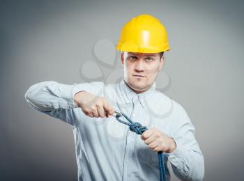 Construction worker holds a rope and carbine. Full length studio shot isolated .